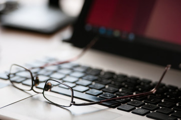 Fototapeta premium Glasses on the laptop. Business concept.