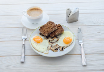 Healthy breakfast, fried eggs with mushrooms and two slices of r
