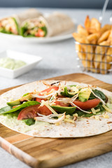 shredded barbecued chicken wraps with carrot, cheese, avocado an