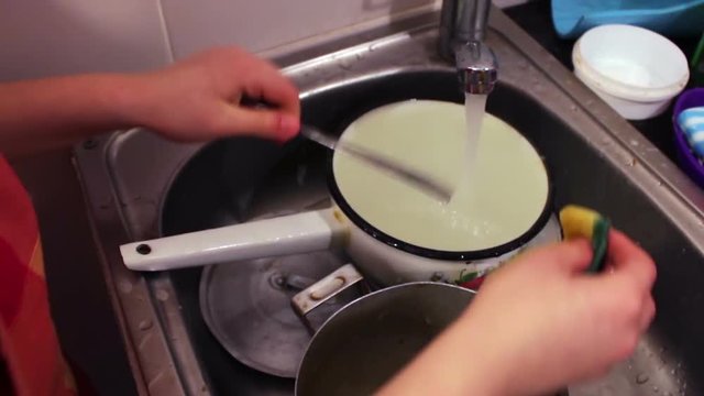 Teenager Boy Washing Dishes