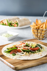 shredded barbecued chicken wraps with carrot, cheese, avocado an
