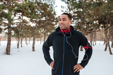 Young man taking a break while doing winter fitness session