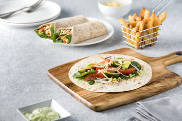 shredded barbecued chicken wraps with carrot, cheese, avocado an