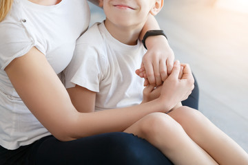 Young boy kissing her mum