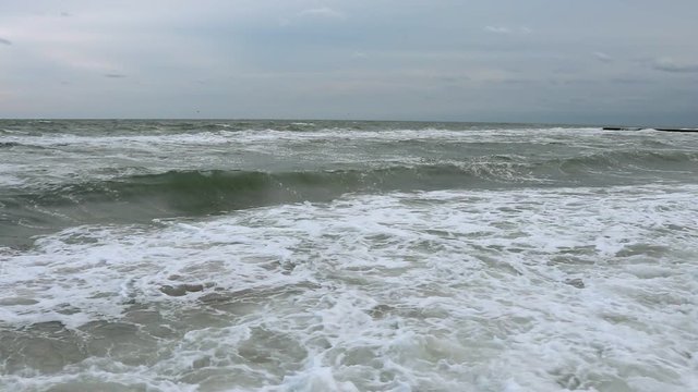View of sea and waves in cloudy weather, wide angle shooting, slow motion