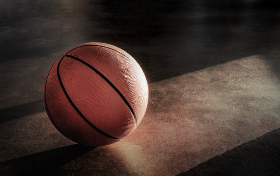 Basketball lay on the floor in a lonely atmosphere.
