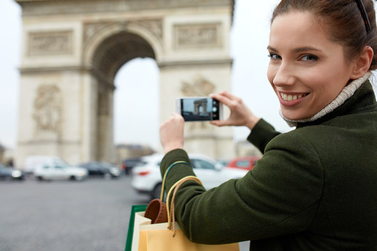 happy young woman visiting Paris. Triumphal arch.