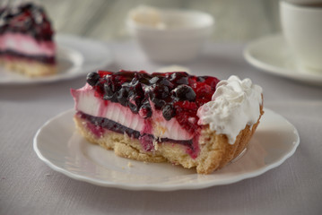 Cake dessert with cream, currants, cherries and coffee
