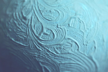 Fototapeta na wymiar Paint texture in macro against a blue background.