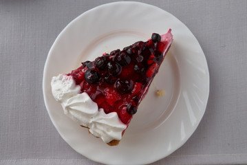 Cake dessert with cream, currants, cherries