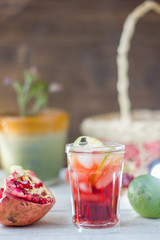 Fresh pomegranate drink - lemonade or cocktail with lime and ice