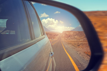 Reflection of the road in a car mirror.