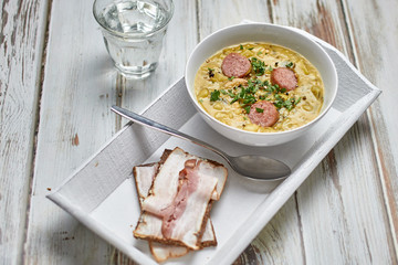 Traditional Dutch pea soup with smoked sausage and rye bread with bacon.