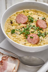 Traditional Dutch pea soup with smoked sausage and rye bread with bacon.