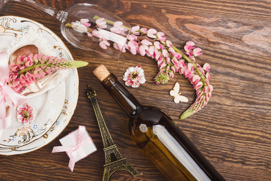 Pink lupins and tableware on the wooden table