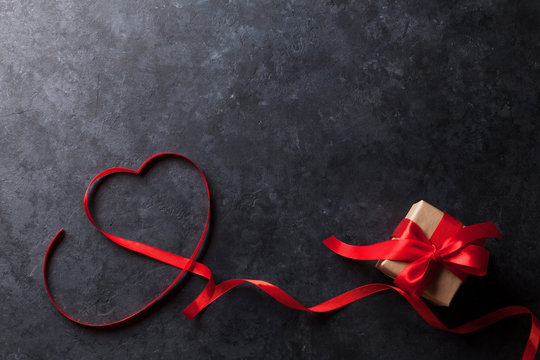 Valentines day. Heart shaped red ribbon and gift