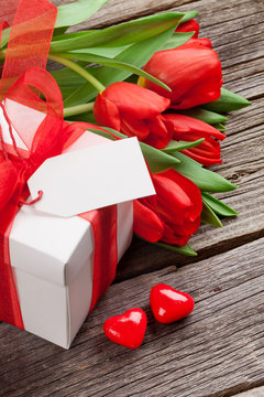 Valentines day gift box and red tulips