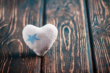 Heart made of cloth on wood desk