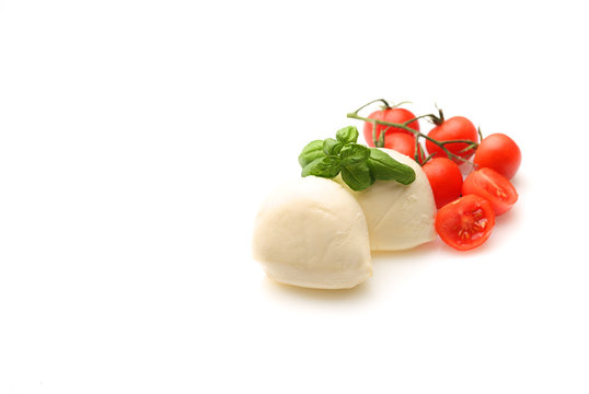 Mozzarella with cherry tomatoes,oil and basil on white background