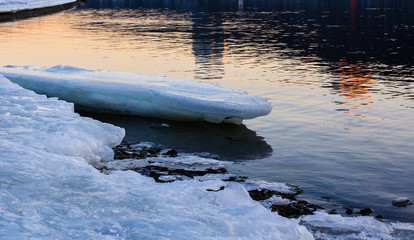 Ice melting on the coast at sunset