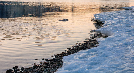 Melting ice coast at sunset