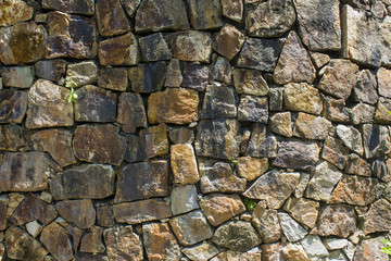 Brown stone wall texture and background. Closeup view of the old stone wall.