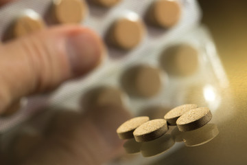 Man takes  painkiller tablets