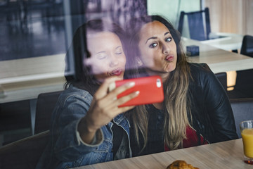 two female mixed race friends having fun together