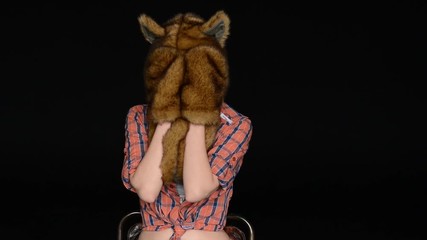 beautiful sexy girl showing a fur hat with funny ears