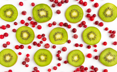Fototapeta premium Fresh fruit kiwi and cranberries closeup of a flat background