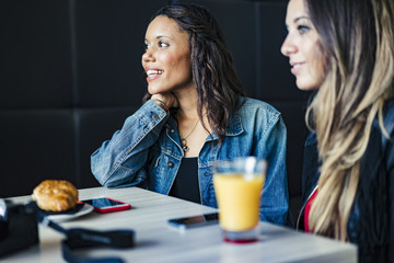 two female mixed race friends having fun together