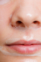Fototapeta premium Close up woman in facial peel off mask.