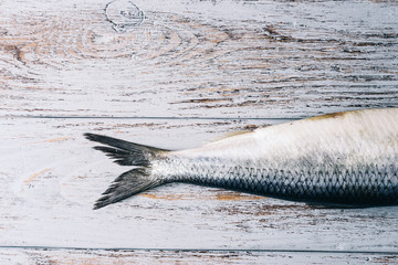 Raw fresh fish on wooden table