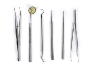 Dental Instruments arranged on white table.