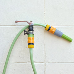 Rubber hose and nozzle install with white wall