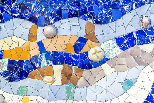 Closeup of mosaic of colored ceramic tile by Antoni Gaudi at his