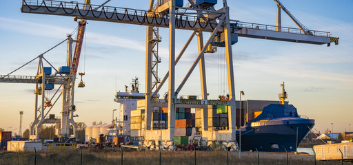 unloading a container ship in the sea port in Szczecin