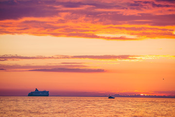 Fototapeta na wymiar Amazing gold orange sky and water of Baltic sea at sunset