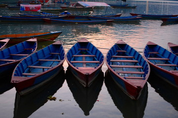 Fototapeta na wymiar Boats parked in Pokhara lake, Nepal, around sunset