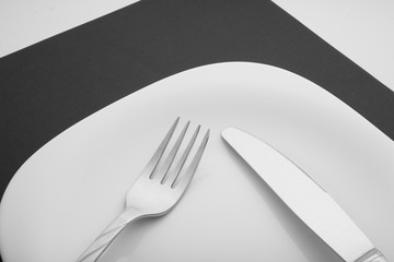 knife, fork and plate on a white background