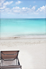 Comfortable chair on beach area with sea