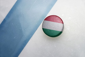old hockey puck with the national flag of hungary.