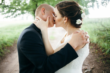 Fototapeta premium Happy bride and groom on their wedding. Newlyweds kissing.7