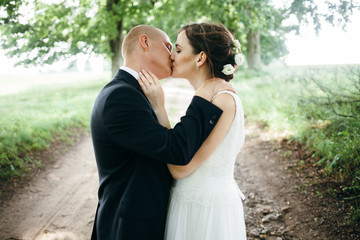 Happy bride and groom on their wedding. Newlyweds kissing.7