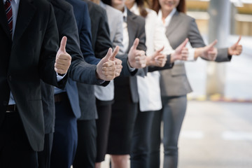 smart  business team standing show symbol like on hand