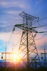 Impression network at transformer station in sunrise, high voltage up to yellow sky take with...