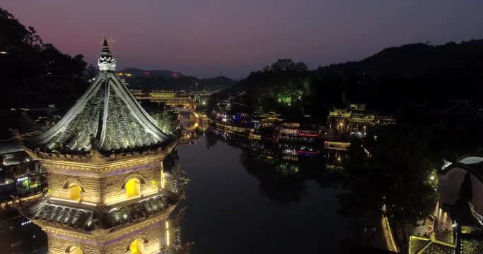 Fenghuang Ancient Town. Located in Fenghuang County. Southwest of HuNan Province, China. View of illuminated riverside houses.