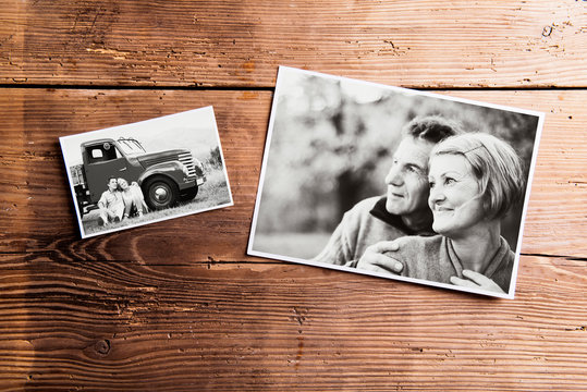 Black-and-white pictures of senior couple. Studio shot on wooden