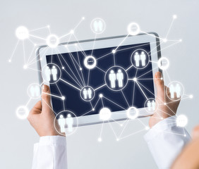 Close of female doctor hands working with tablet pc computer