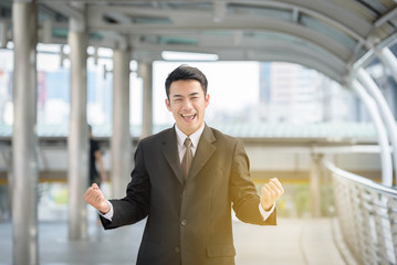 businessman standing show symbol like on hand